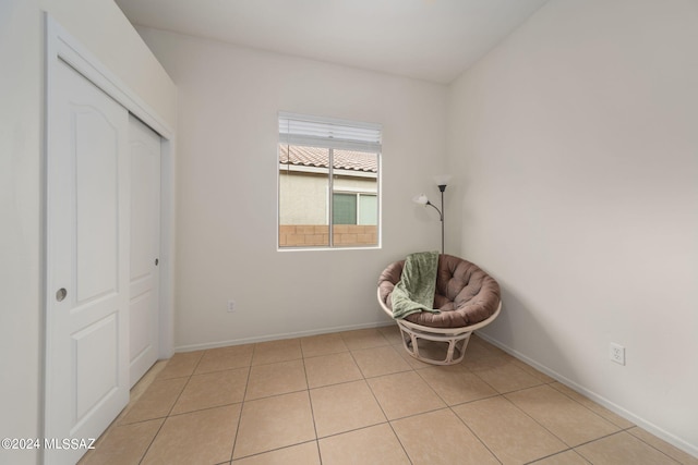unfurnished room with baseboards and light tile patterned floors
