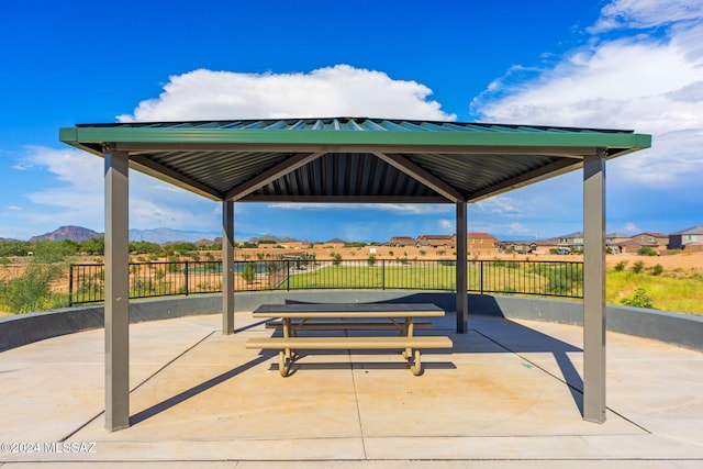 view of patio / terrace with a gazebo, a mountain view, and fence