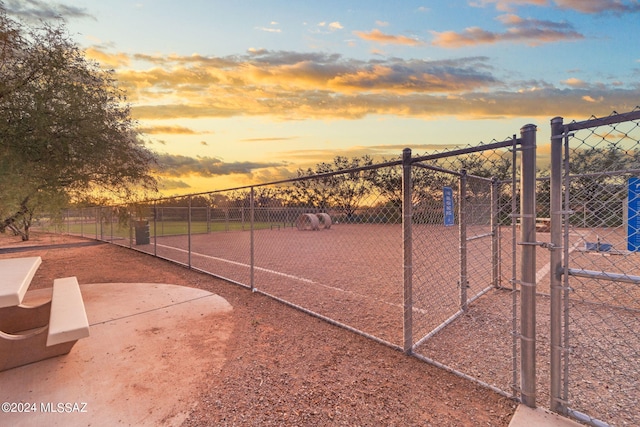 view of sport court with fence and a gate