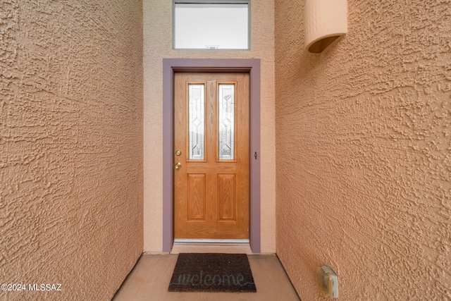 entrance to property with stucco siding