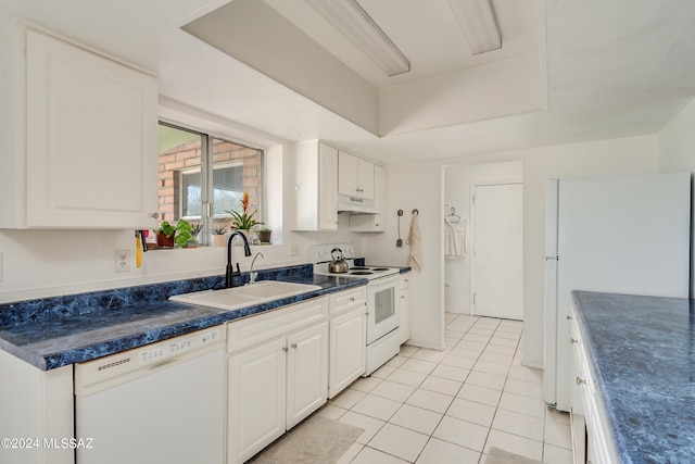 kitchen featuring white cabinets, light tile patterned flooring, sink, and white appliances