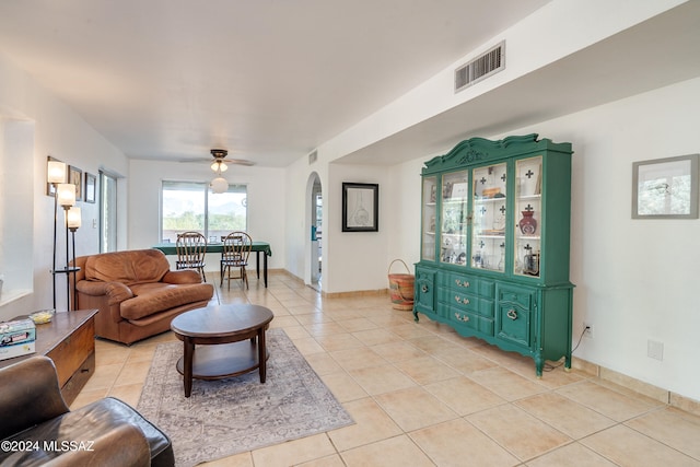 tiled living room with ceiling fan