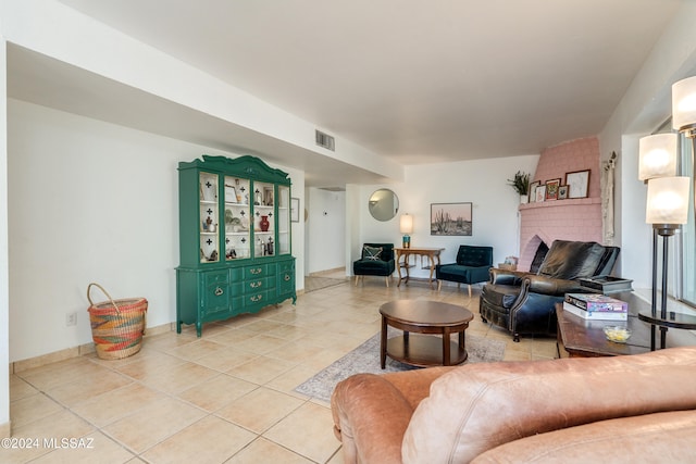 tiled living room featuring a fireplace