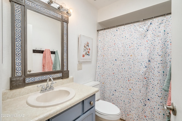 bathroom featuring vanity, toilet, and a shower with shower curtain