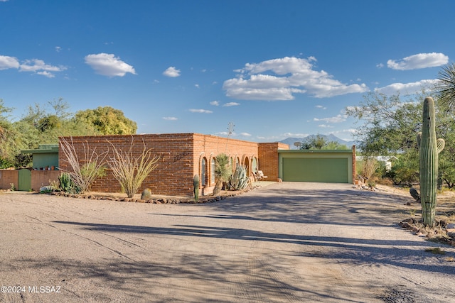 view of front facade with a mountain view and a garage