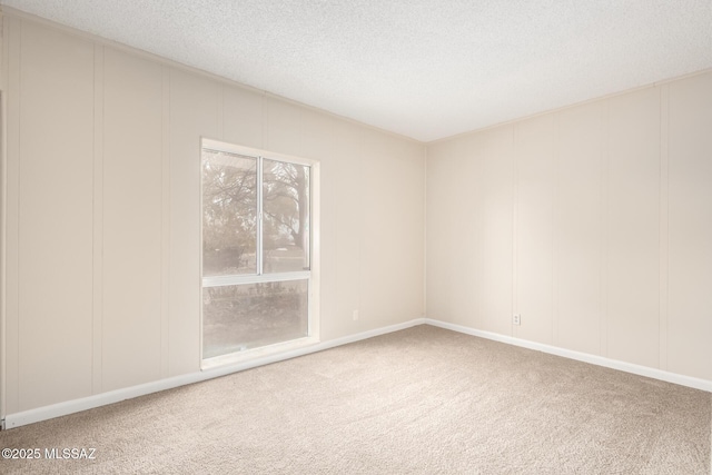 carpeted empty room with a textured ceiling