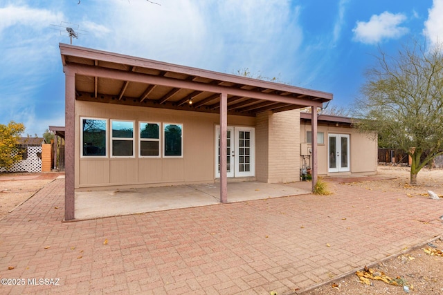 back of property with a patio and french doors