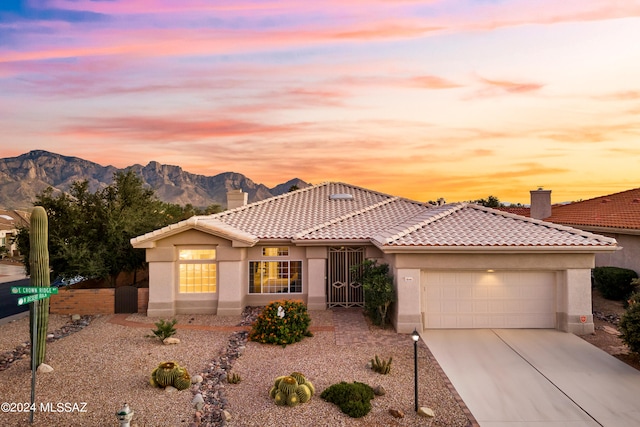 view of front of home featuring a mountain view and a garage