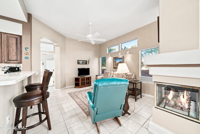 living room featuring ceiling fan and light tile patterned floors