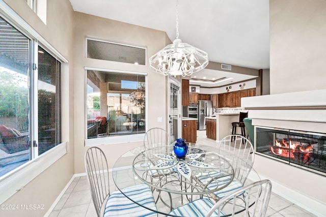 tiled dining area with a notable chandelier