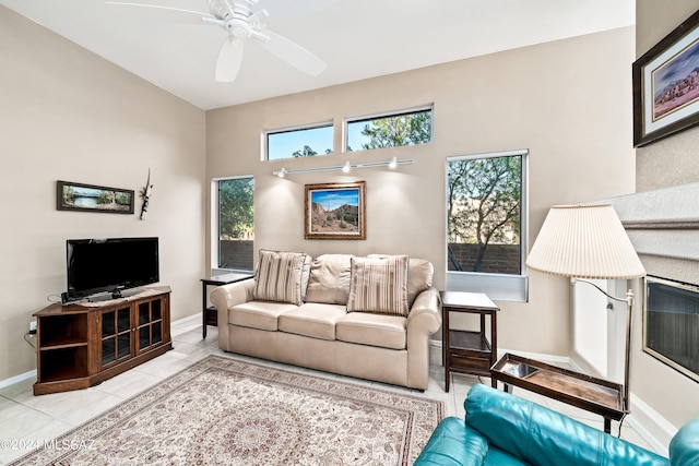 living room featuring light tile patterned floors and ceiling fan