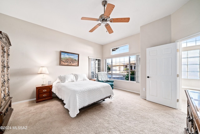 bedroom with light carpet, multiple windows, and ceiling fan