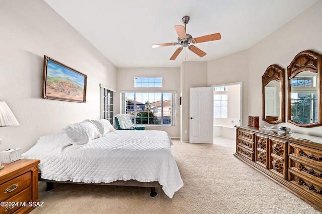 bedroom featuring ensuite bath, carpet floors, and ceiling fan