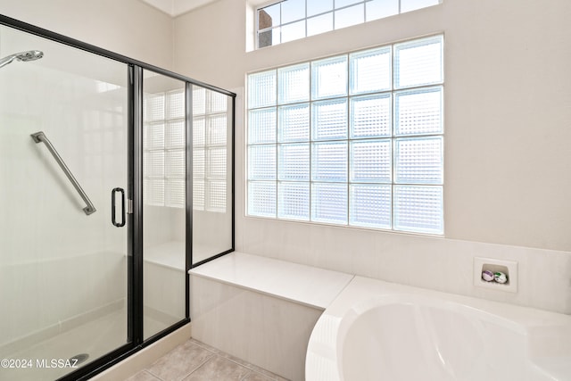 bathroom with shower with separate bathtub and tile patterned floors