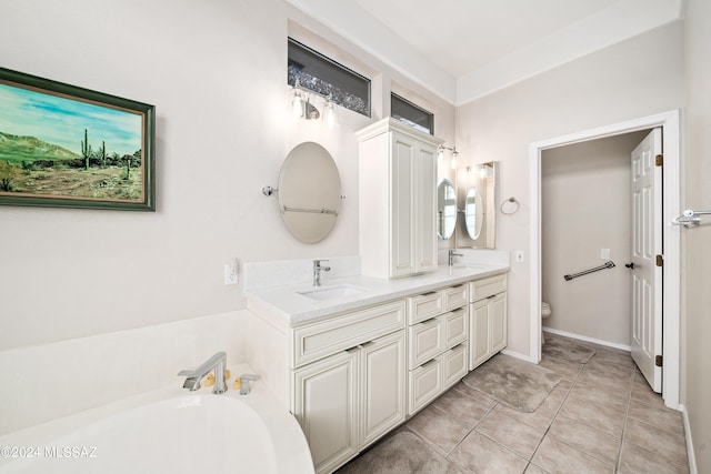 bathroom featuring toilet, vanity, tile patterned flooring, and a bathtub