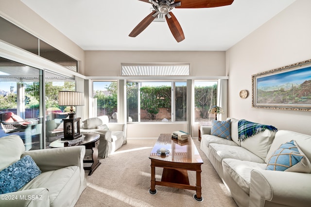 living room featuring light colored carpet and ceiling fan