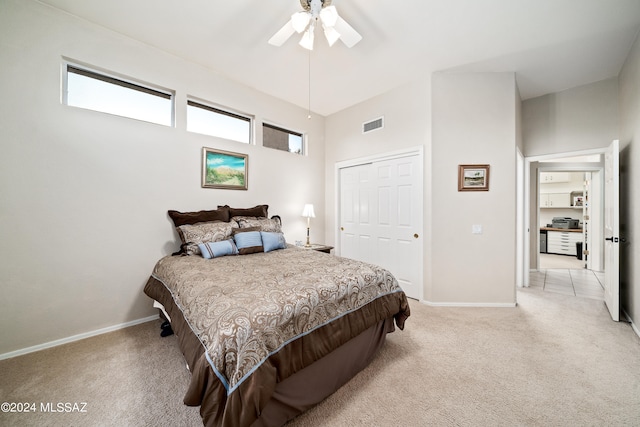 carpeted bedroom with ceiling fan and a closet