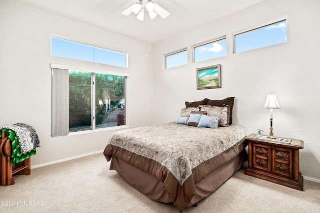 bedroom featuring light colored carpet and ceiling fan