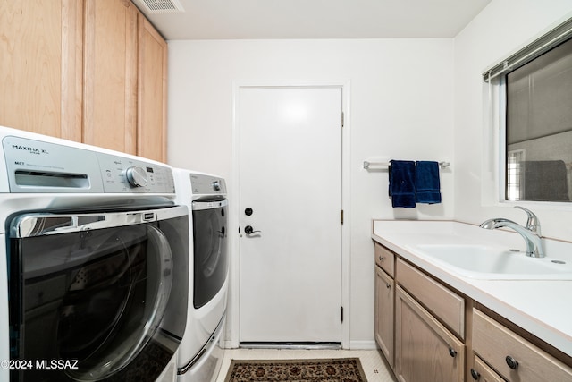 laundry area featuring cabinets, washer and clothes dryer, sink, and light tile patterned floors