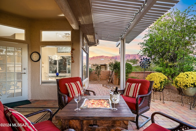 patio terrace at dusk with a pergola and an outdoor living space