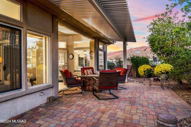 view of patio terrace at dusk