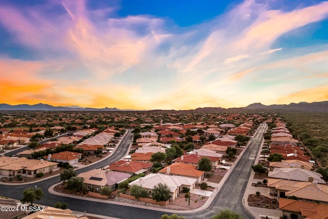 aerial view at dusk featuring a mountain view