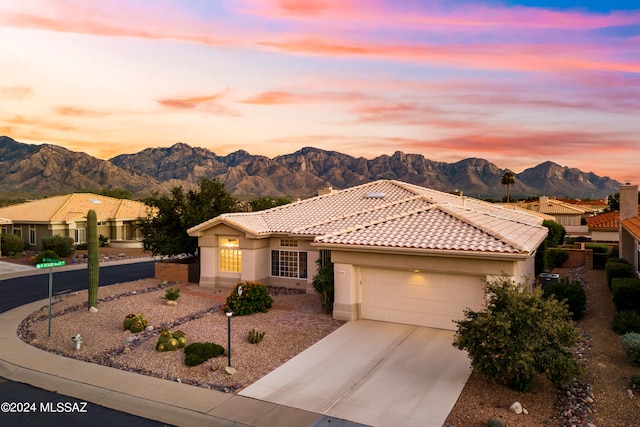 mediterranean / spanish home featuring a mountain view and a garage