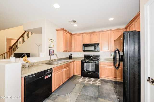 kitchen featuring light brown cabinets, black appliances, and sink