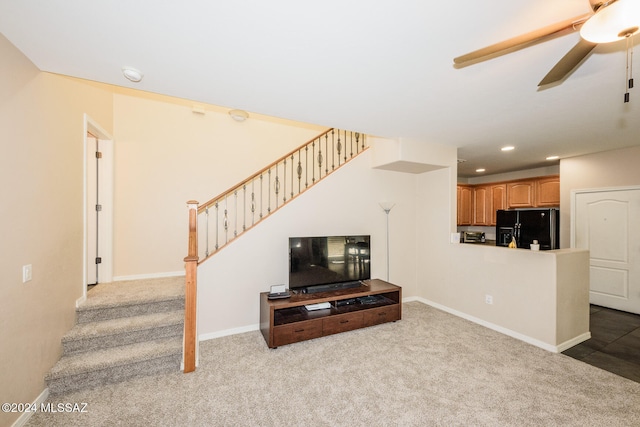 living room featuring light carpet and ceiling fan