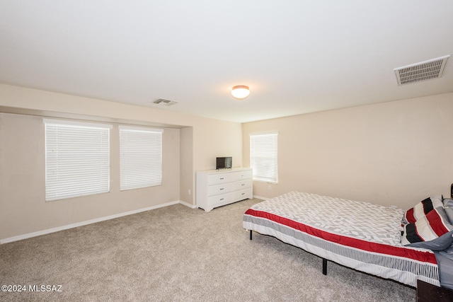 bedroom featuring light carpet