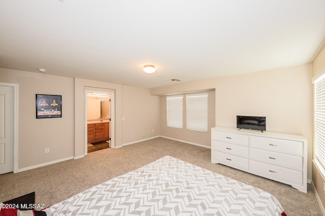 carpeted bedroom featuring ensuite bathroom