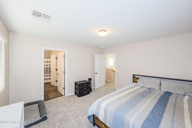 carpeted bedroom with connected bathroom