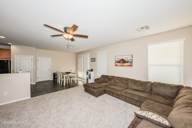 tiled living room featuring ceiling fan