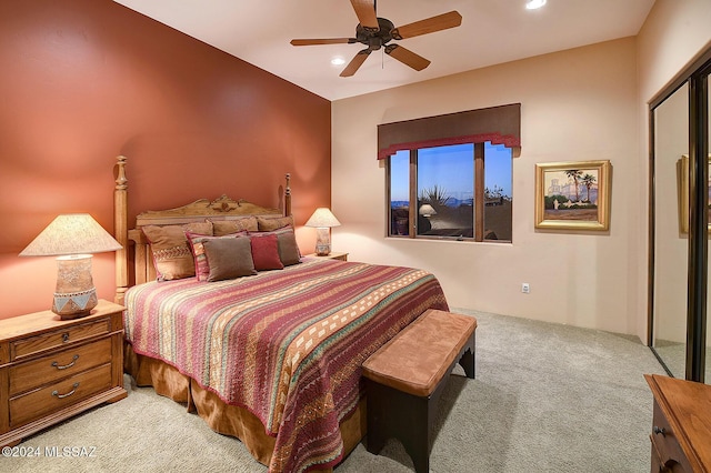 carpeted bedroom with a closet and ceiling fan