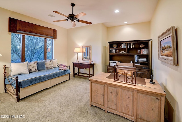 interior space with ceiling fan and light colored carpet