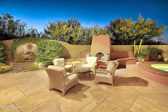 view of patio / terrace with an outdoor living space with a fireplace