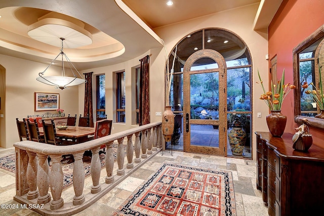 foyer featuring a raised ceiling