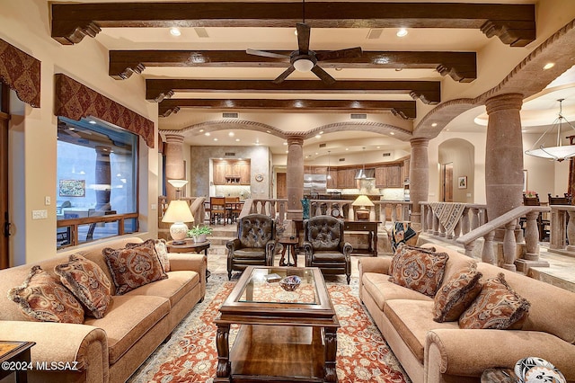 living room featuring ceiling fan, beam ceiling, and ornate columns