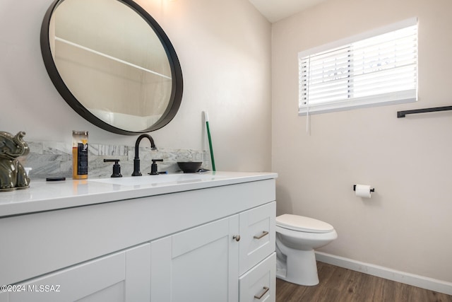 bathroom with vanity, toilet, and wood-type flooring