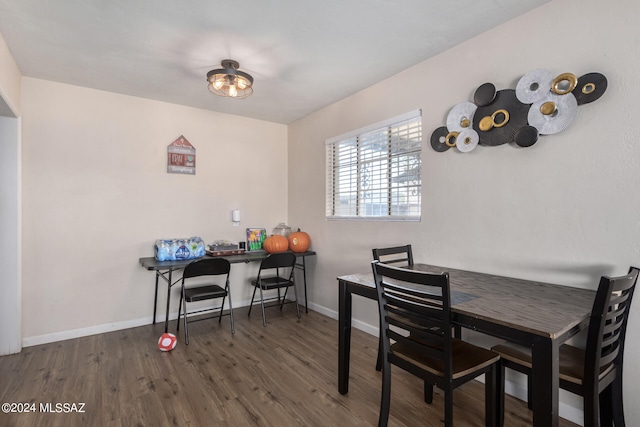 dining area with dark hardwood / wood-style flooring