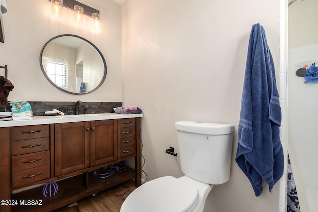 bathroom featuring vanity, hardwood / wood-style floors, and toilet