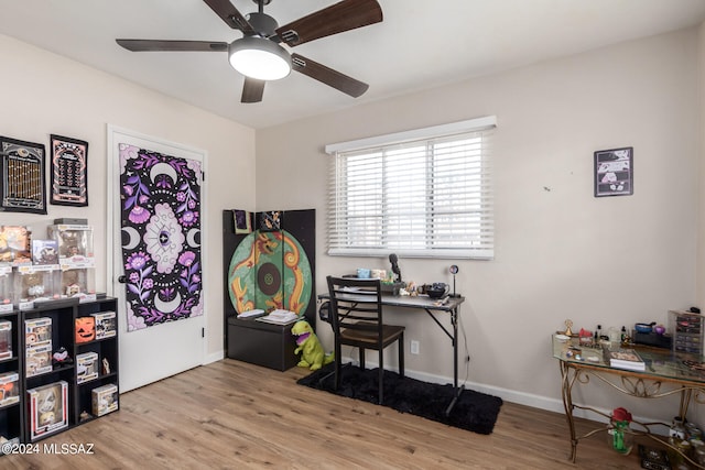 office with light hardwood / wood-style floors and ceiling fan