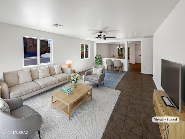 tiled living room with ceiling fan