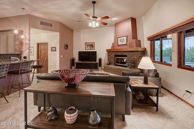 living room with light tile patterned floors, vaulted ceiling, and ceiling fan