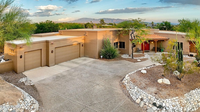 southwest-style home with a mountain view and a garage