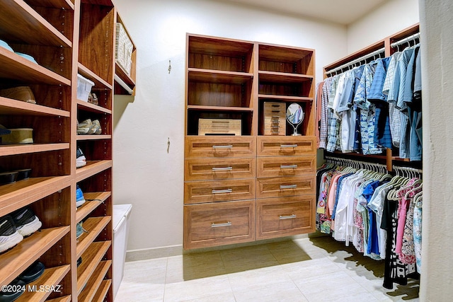 spacious closet with light tile patterned floors