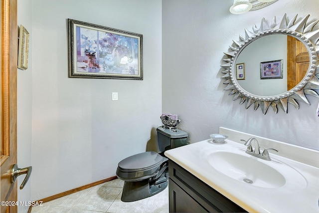 bathroom with tile patterned flooring, vanity, and toilet