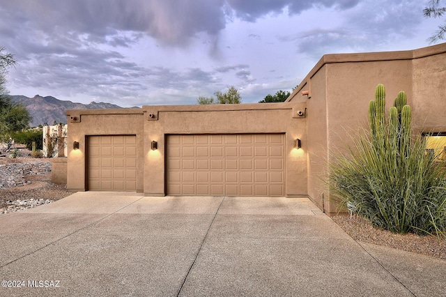 view of front of home with a garage and a mountain view