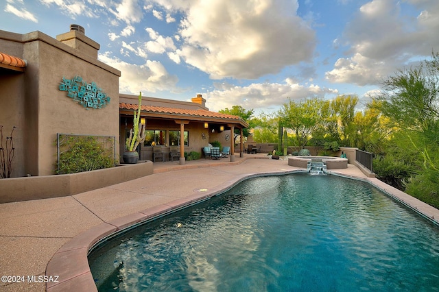 view of pool featuring an in ground hot tub and a patio area