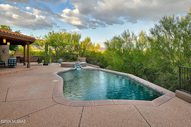 view of swimming pool with an in ground hot tub and a patio